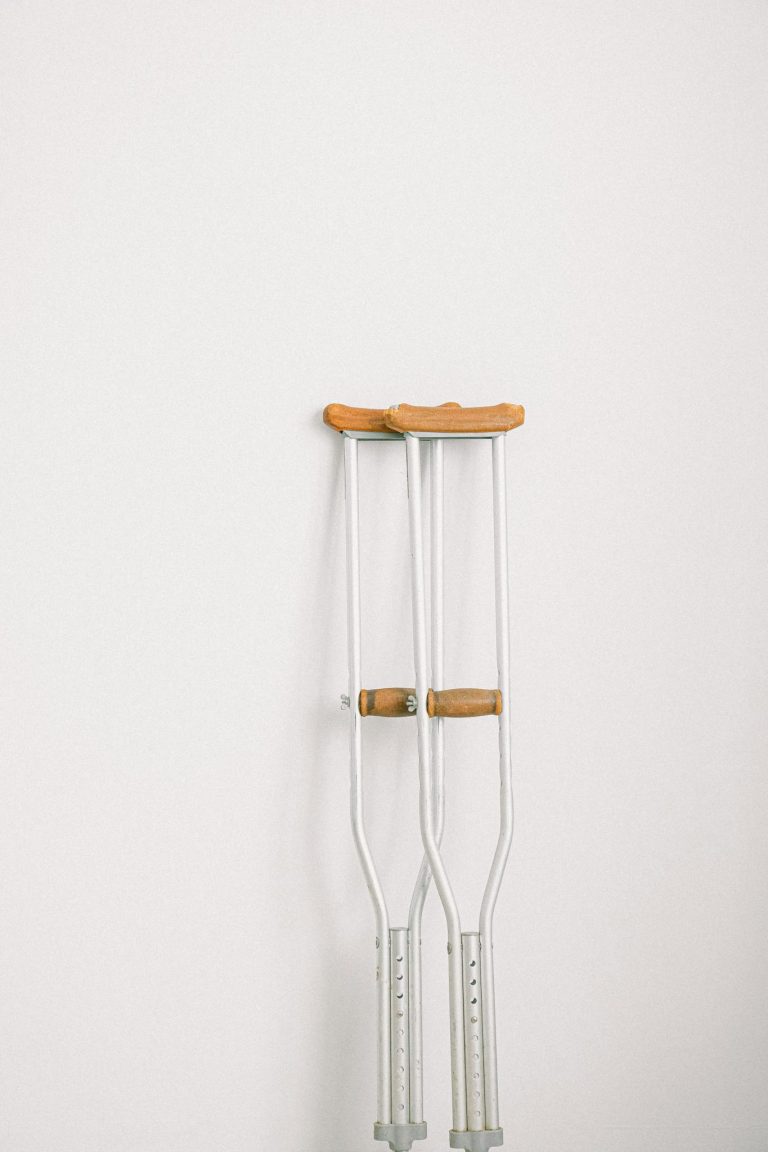 Crutches against light white wall